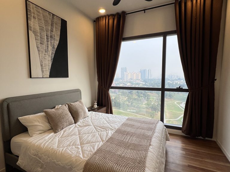Master bedroom with grey upholstered bed, white bedding and beige throw, framed artwork and a window view