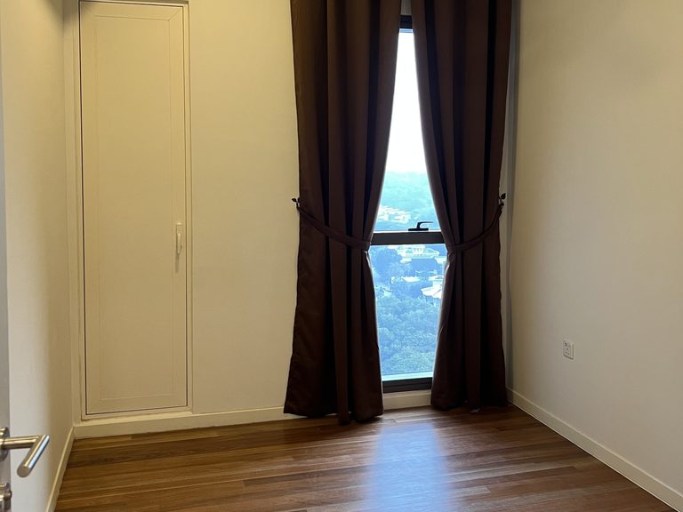 Second bedroom with dim-out curtains and timber flooring, left unfurnished