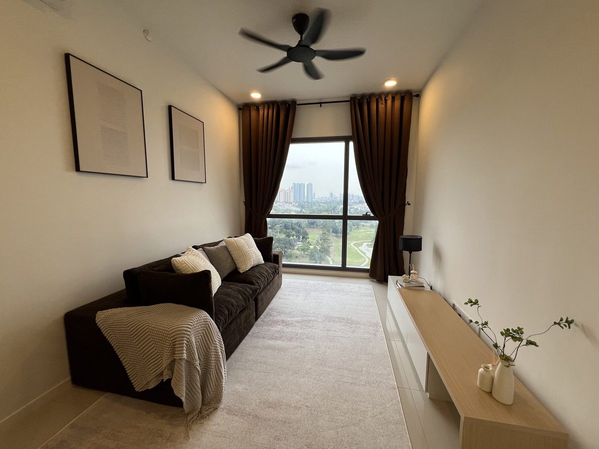 Living room with charcoal sofa, cream rug, oak floating console and full-height curtains