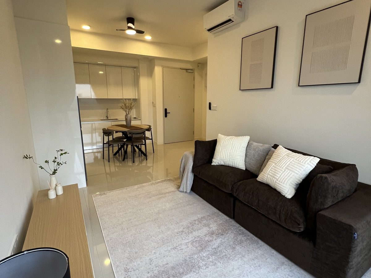 Living room seen from the console end, with the dining table and entrance beyond